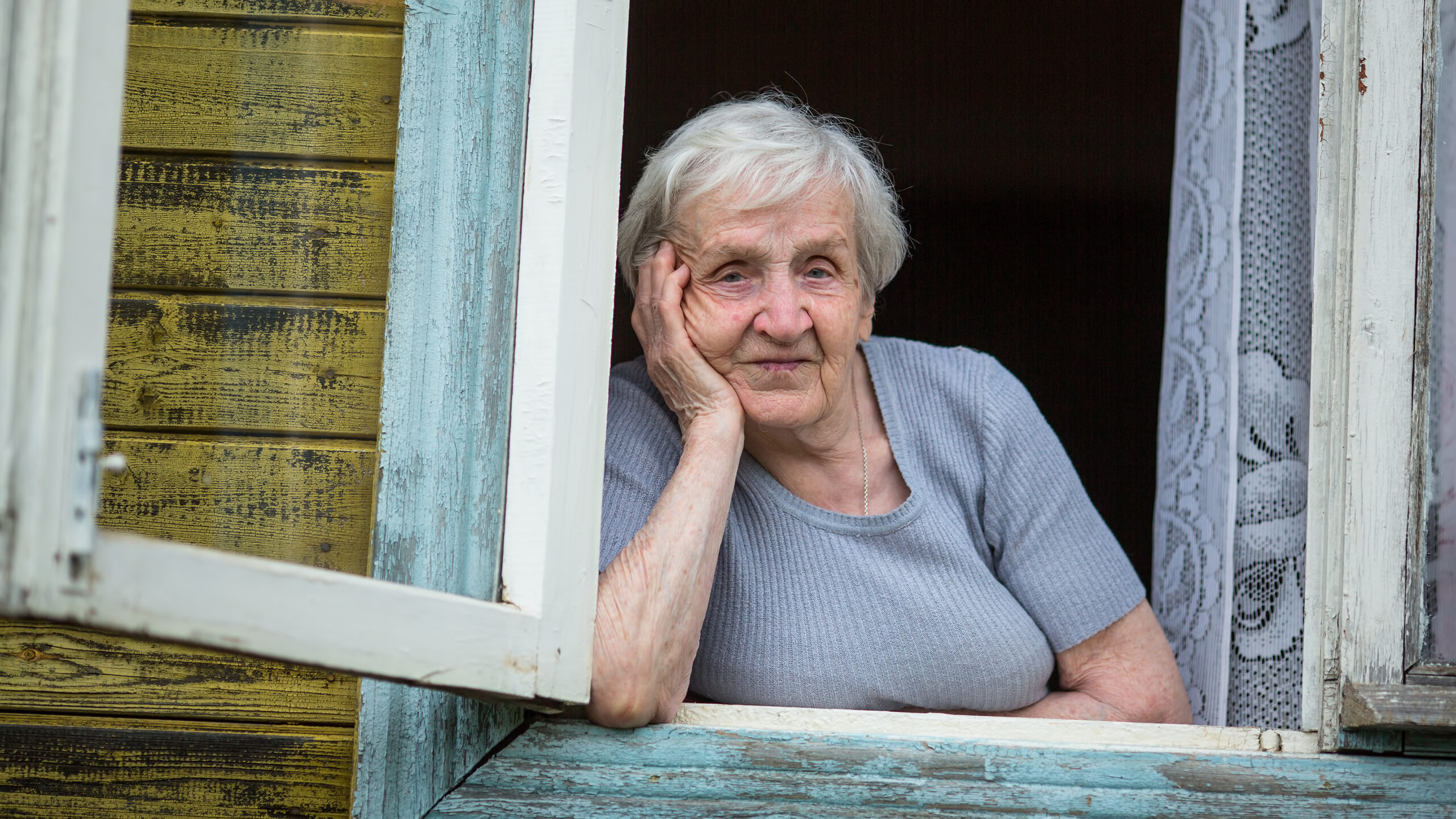 Senior Woman in House Window